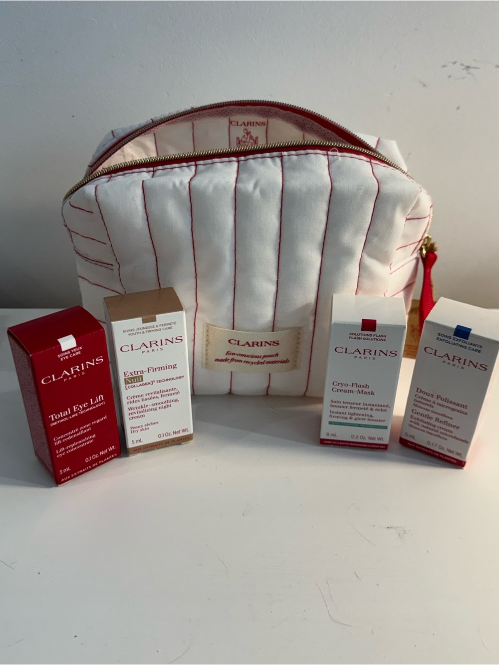 Clarins NIB skincare bundle with striped bag 5 piece set